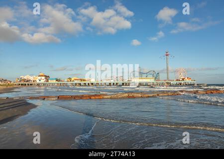 Galveston, USA - October 28, 2023: Pleasure Pier seen from the water in Galveston Island. Stock Photo