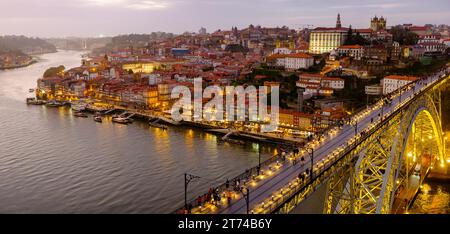 Panoramic image, old city Porto skyline, Oporto, Luís I Bridge, Douro River, sunset cityscape panorama, Cais da Ribeira old houses, Porto, Portugal Stock Photo