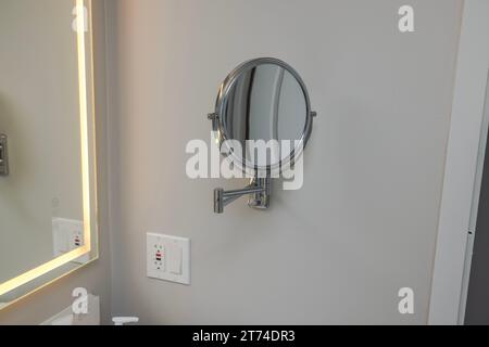 Interior view of hotel bathroom equipped with mirror for comfortable hygiene routines for hotel guests. Stock Photo