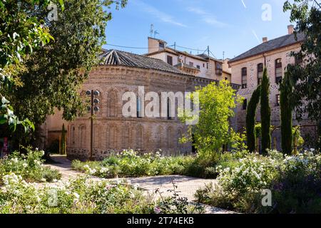 Mosque of Cristo de la Luz (Mezquita del Cristo de la Luz), now catholic church building, exterior stone facade with lush garden around, Toledo, Spain Stock Photo