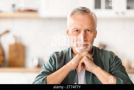 Closeup Portrait Of Smiling Grey-Haired Man Posing in Kitchen Interior, Stock Photo