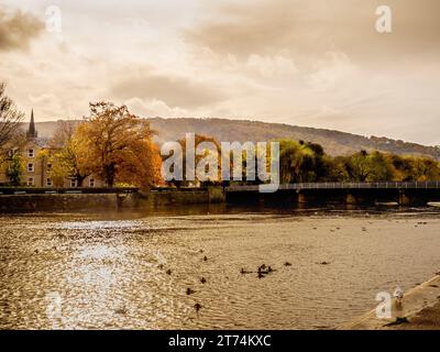 River Wharfe and Otley Bridge with the picturesque Otley Chevin Forest Park in the distance, on an autumn day. Stock Photo