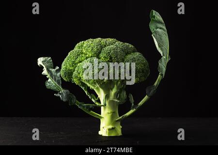 Fresh broccoli florets on black rustic background Stock Photo