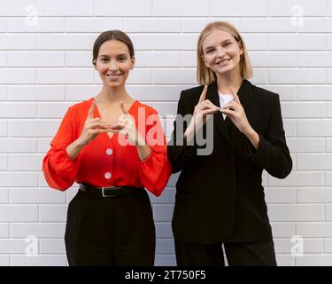 Front view smiley women using sign language Stock Photo