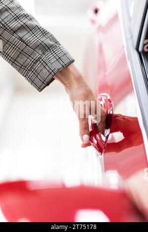 Businesswoman opening car door Stock Photo