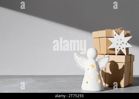 Epiphany day angel figurine with gift boxes copy space Stock Photo