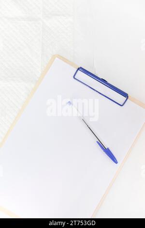 Pen white paper clipboard against white background Stock Photo