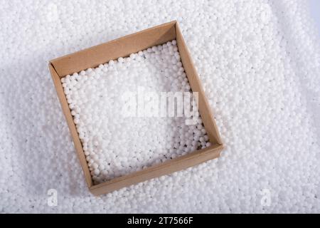 Box on little white polystyrene foam balls Stock Photo