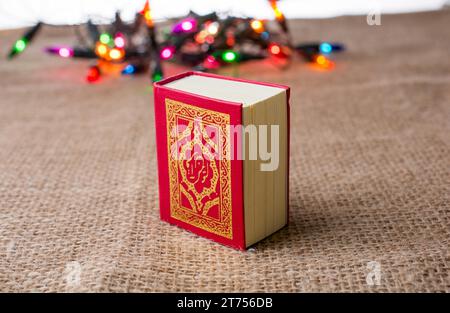 Islamic Holy Book Quran with lights behind Stock Photo