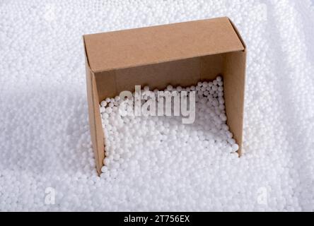 Box on little white polystyrene foam balls Stock Photo