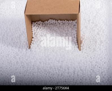 Box on little white polystyrene foam balls Stock Photo