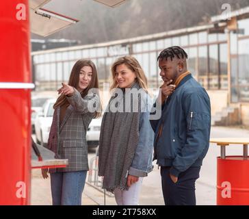 Best friends getting something from food truck Stock Photo