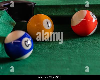 Billiard table setup featuring colorful pool balls, ready for an exciting game of cue sports Stock Photo