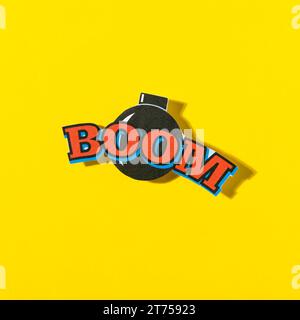 Boom comic text speech bubble with bomb yellow background Stock Photo