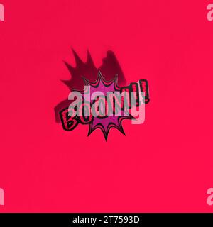 Boom comic text speech bubble pop art style sound effect red backdrop Stock Photo