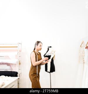 Female designer working cloth shop Stock Photo