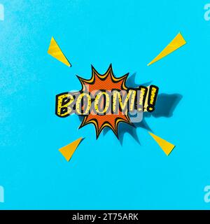 Pop art comics boom speech bubble against blue backdrop Stock Photo
