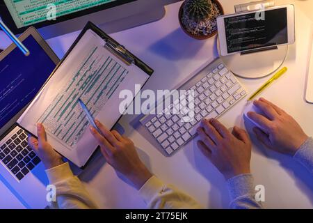Programmers working in office at night, top view Stock Photo