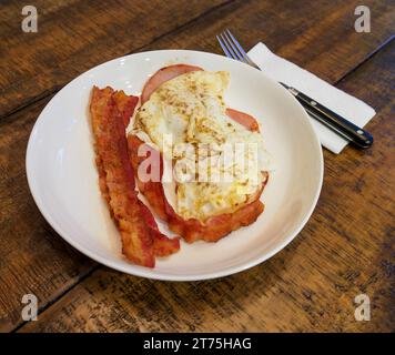 Bacon and fried eggs breakfast an American traditional breakfast on a table. Stock Photo
