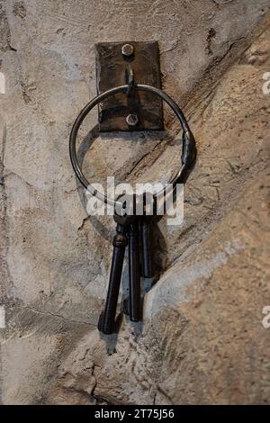 Rusty keys hanging near a old west jail house cage door. Stock Photo