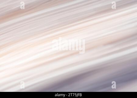 Abstract light painting with a soft, fabric-like  texture and diagonal line pattern, with muted color gradient of creams, yellows, and violet. Intenti Stock Photo