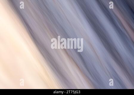 Abstract light painting with a soft texture and diagonal line pattern, with muted colors of blue, yellow, and violet. Intentional camera movement. Stock Photo