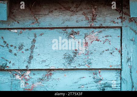 Distressed barn siding with bright teal pain Stock Photo