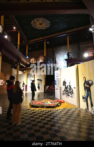 People looking at art inside the Banksy Museum - The World of Banksy – Brussels, Belgium – 25 October 2023 Stock Photo