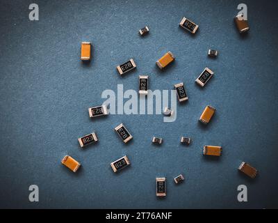 Electronic components, many ceramic capacitors and chip resistors on PCB background Stock Photo