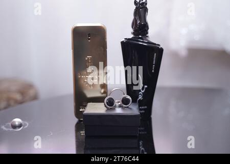 An array of perfume bottles displayed on a transparent glass table Stock Photo