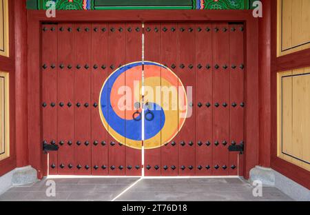 Close up of Traditional Korean Wooden Door with Red and Blue and brass details Stock Photo