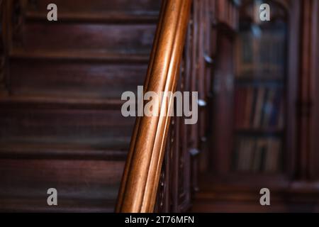 warm gloomy background, detail of a classic interior, wooden staircase railings Stock Photo