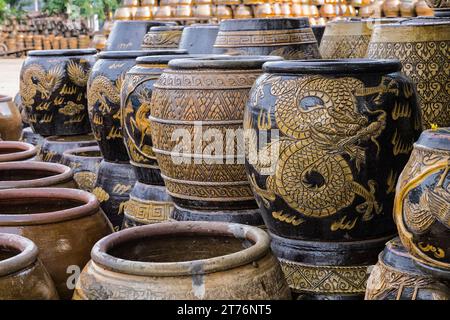 Intricately hand-painted Thai dragon jars display their unique patterns, a testament to Ratchaburi's rich pottery tradition, Ratchaburi, Thailand Stock Photo
