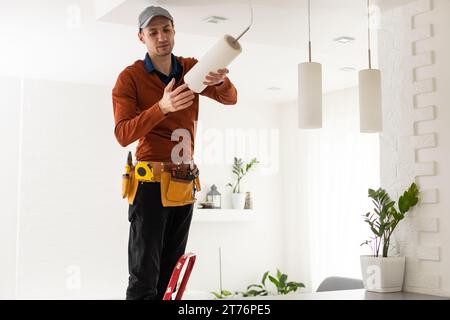 Electrician man working on exterior light, install LED replacement lamp at home. Maintenance concept. Stock Photo