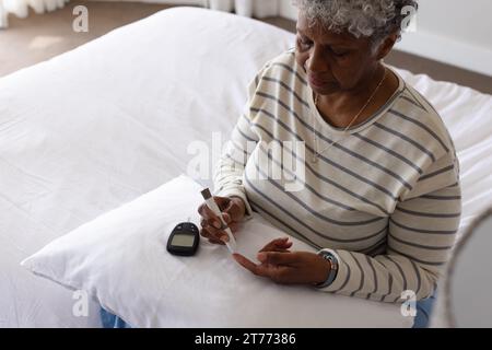 Senior african american woman using epi pen Stock Photo