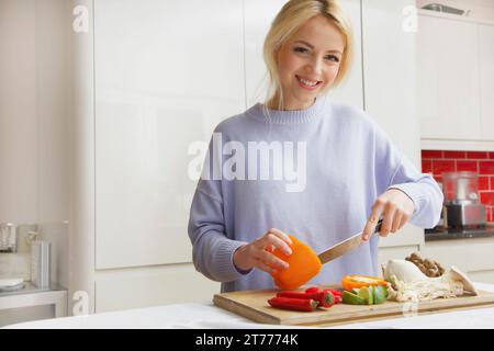 Smiling Woman Preparing Vegetables Stock Photo