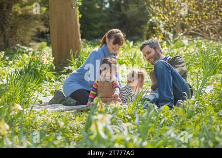 Happy Family Sitting in Garden Stock Photo