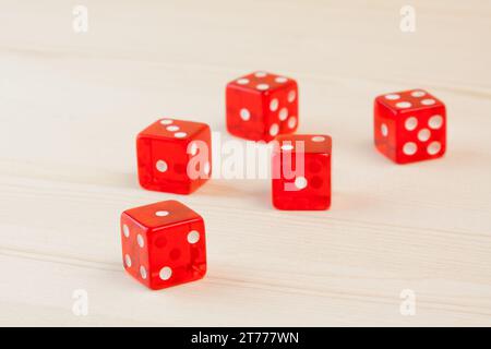 group of five red dices on wood table Stock Photo