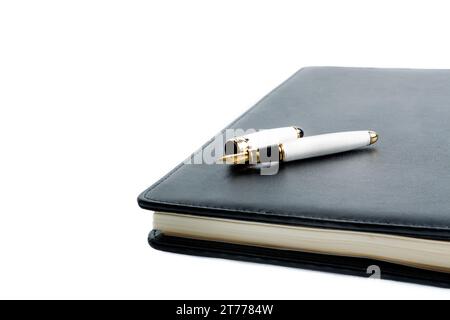 notebook and pen in composition on white background Stock Photo