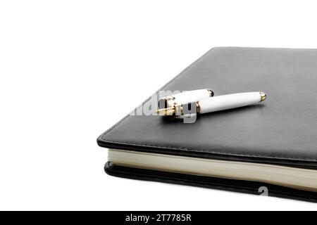 notebook and pen in composition on white background Stock Photo