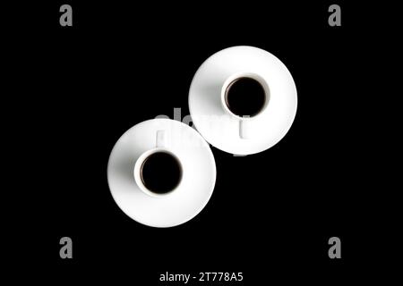 two cups of black coffee over the black background Stock Photo