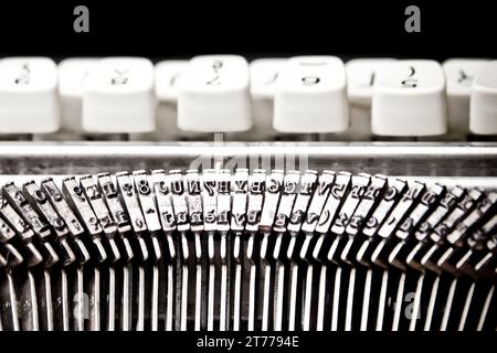 detail of type bars and white buttons of typewriter on black background Stock Photo