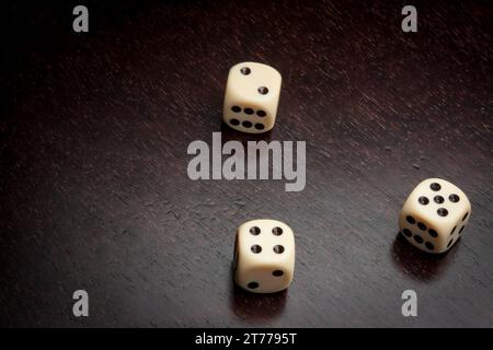 detail of dice on old wood table with space for text Stock Photo