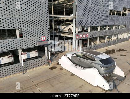 YANTAI, CHINA - NOVEMBER 13, 2023 - AGV (Automated Guided Vehicle) transfers commercial vehicles from the warehouse to the handover area at the commer Stock Photo