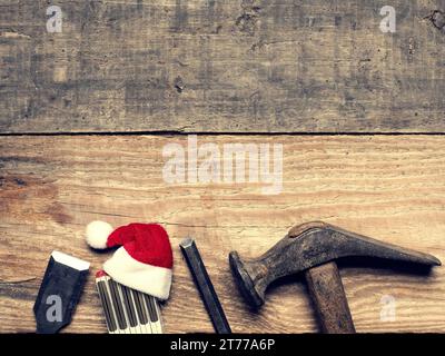 Old used carpenter tools with the hat of Santa, industrial Christmas background with space for text or image Stock Photo
