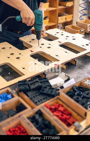 Man is working with electric screwdriver, hand tools concept Stock Photo