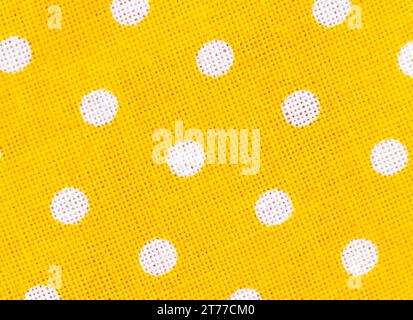 regular yellow fabric texture background with white polka dots Stock Photo