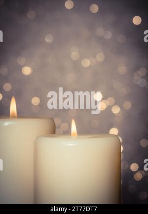 candles with flame on bokeh background and space for text Stock Photo