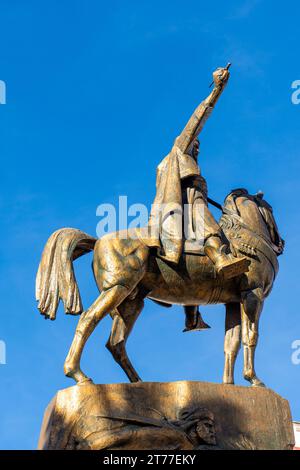 Low-angle view of Emir Abdelkader's statue against a blue sky in Algiers City. Stock Photo