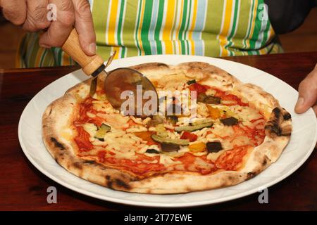 Cutting pizza. Stock Photo